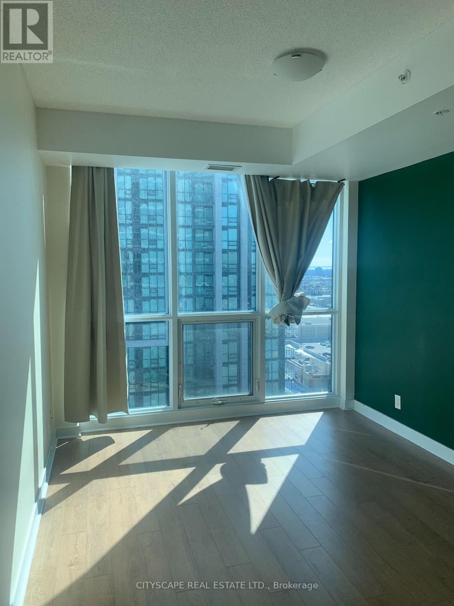 A room with a large window and a view of a cityscape.