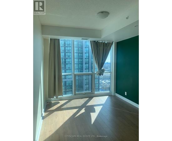 A room with a large window and a view of a cityscape.