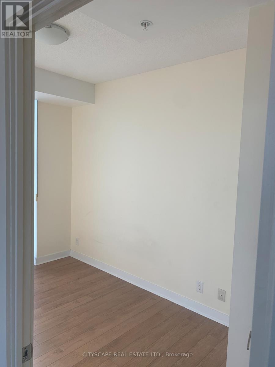 A room with white walls and wooden flooring.