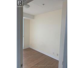 A room with white walls and wooden flooring.