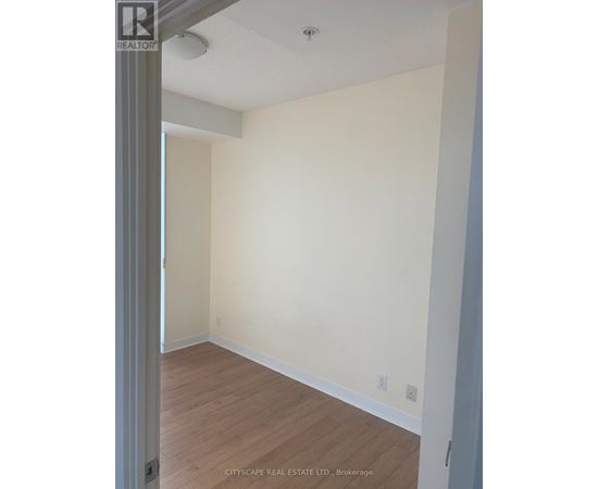 A room with white walls and wooden flooring.