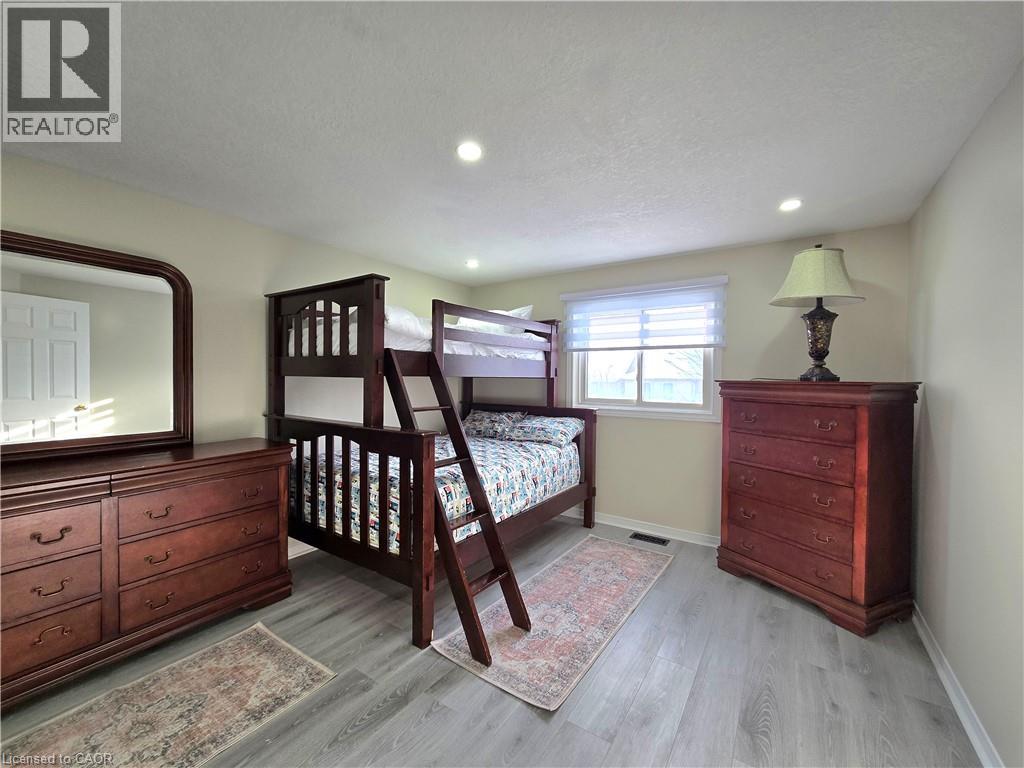 A bedroom with a bunk bed and a dresser.