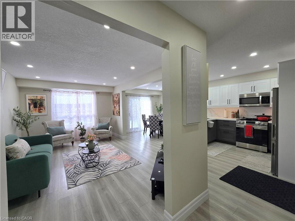 A well-lit living room with a green couch and a coffee table in the center.