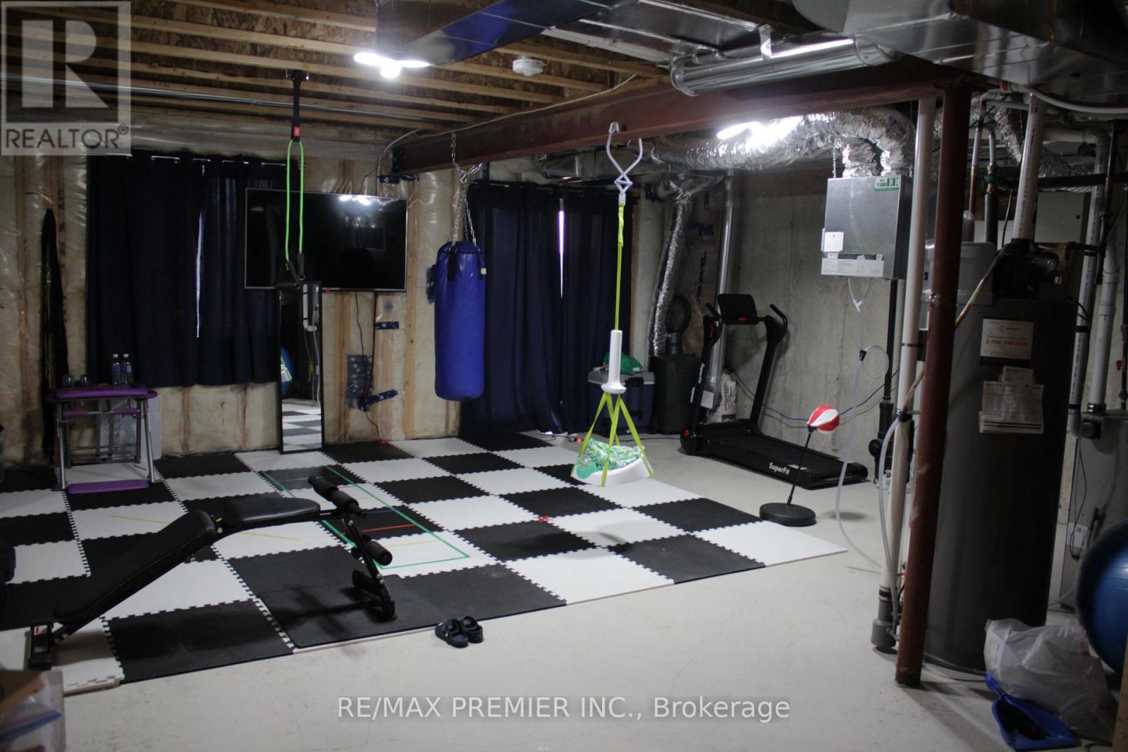 A gym with a checkered floor and a punching bag.