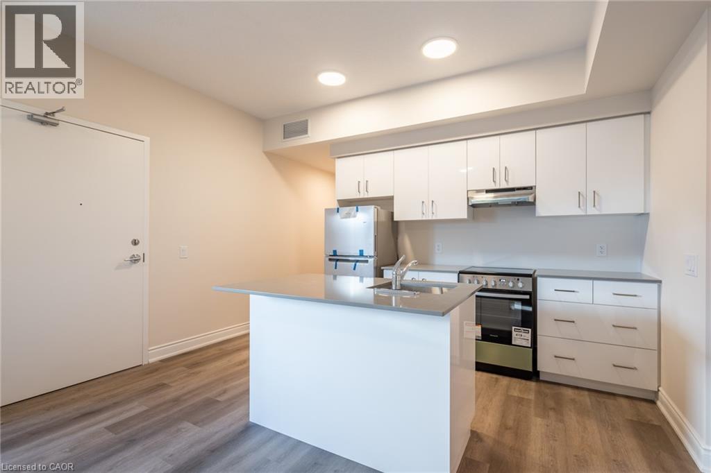 A white kitchen with a sink and stove.
