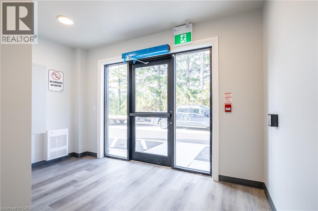 A white hallway with a blue sign on the door.