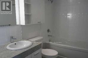 A bathroom with a sink, toilet and bathtub.