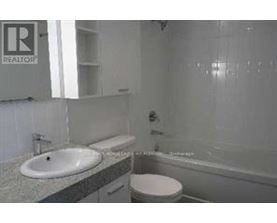 A bathroom with a sink, toilet and bathtub.