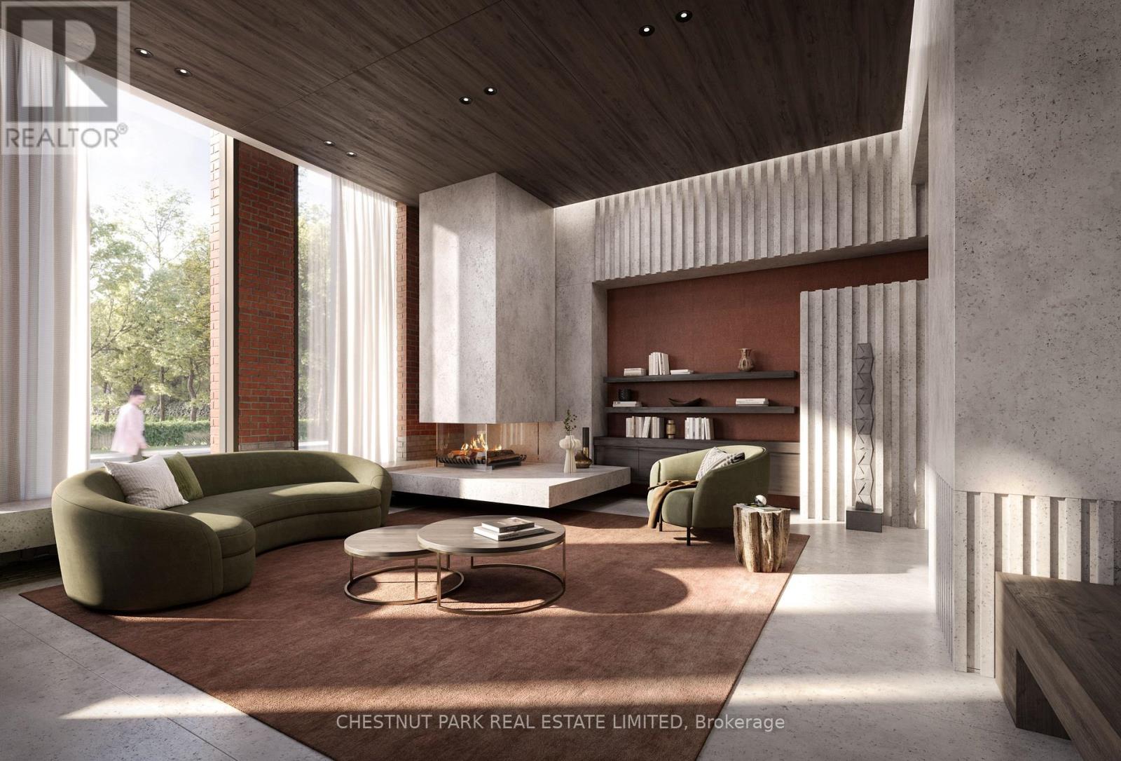 A modern living room with a green sofa and a fireplace.
