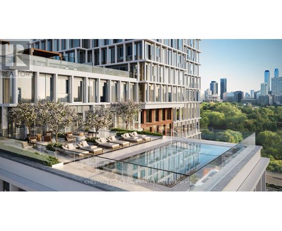 A modern building with a pool and lounge area in the foreground.