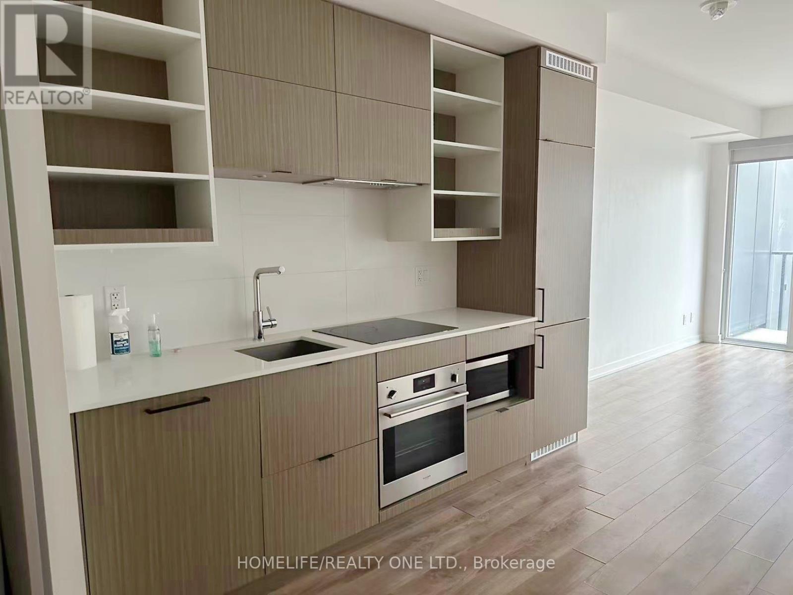 A kitchen with brown cabinets and a white countertop.