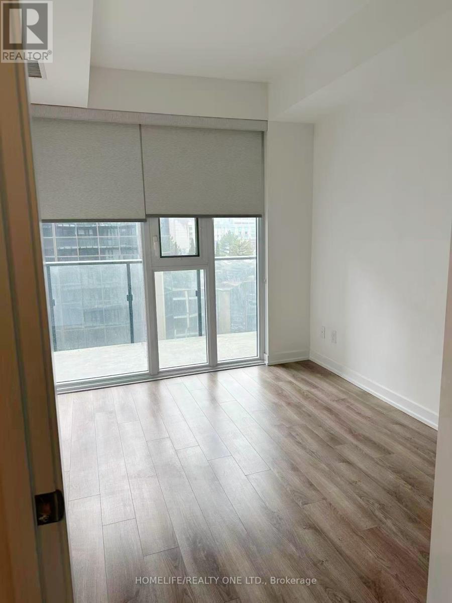 A room with a sliding glass door leading to a balcony.