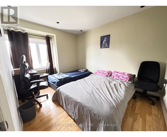 A bedroom with a large bed and a large picture on the wall.