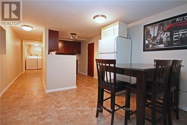A kitchen area with a table and chairs.
