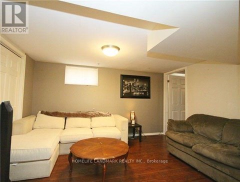 A living room with a white couch and a brown coffee table.