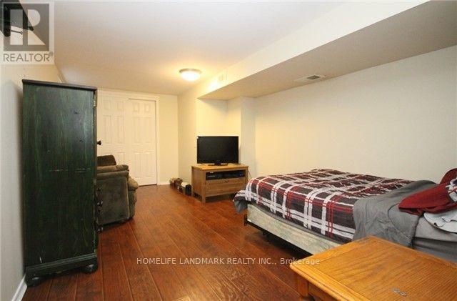 A bedroom with a bed, dresser, and a television.