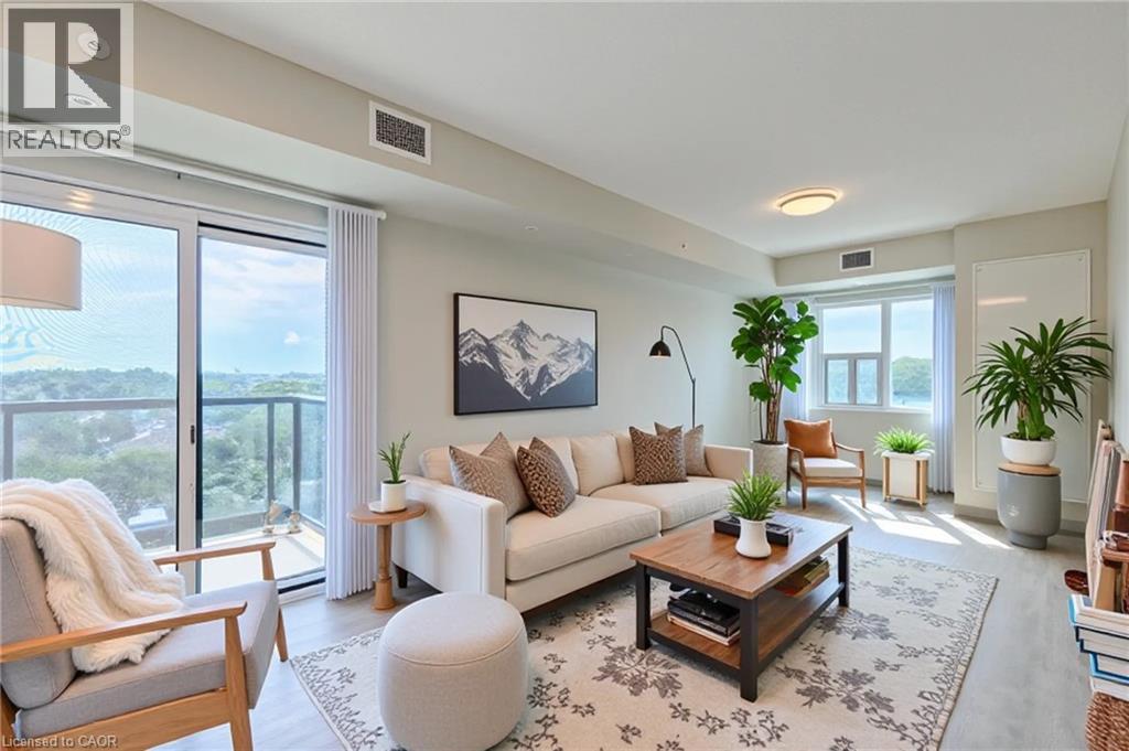 A living room with a couch, chairs, and a rug.