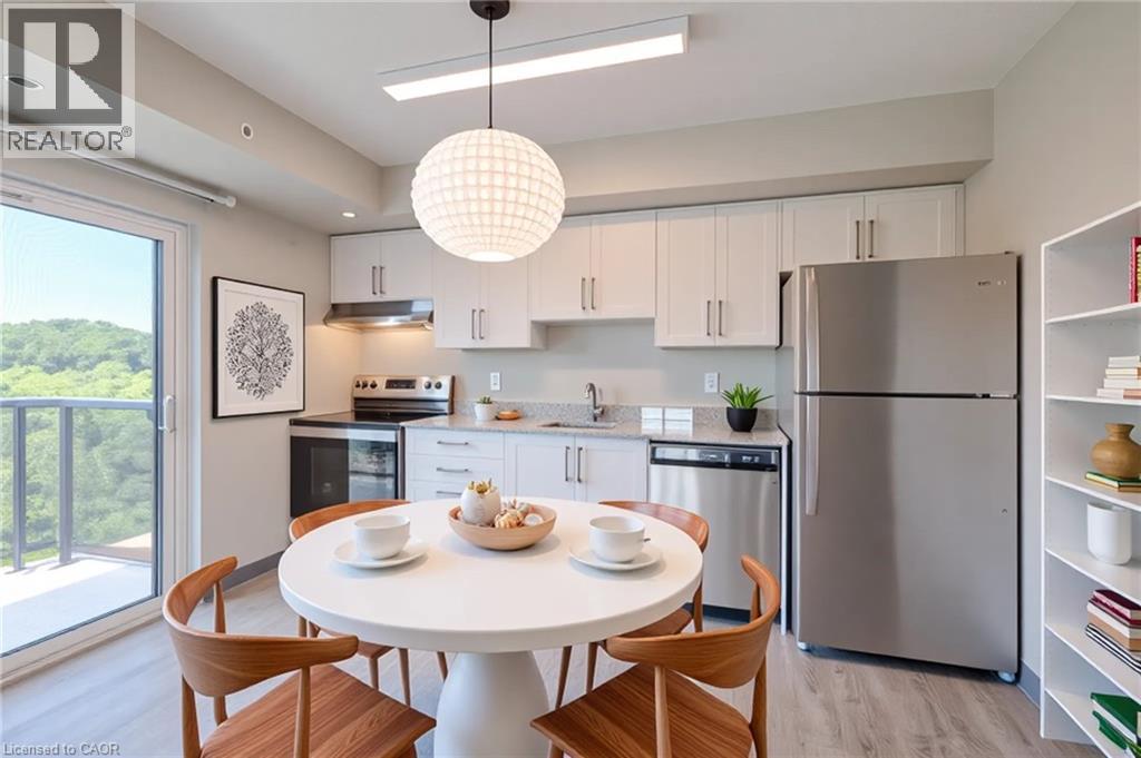 A modern kitchen with a dining table set for two.