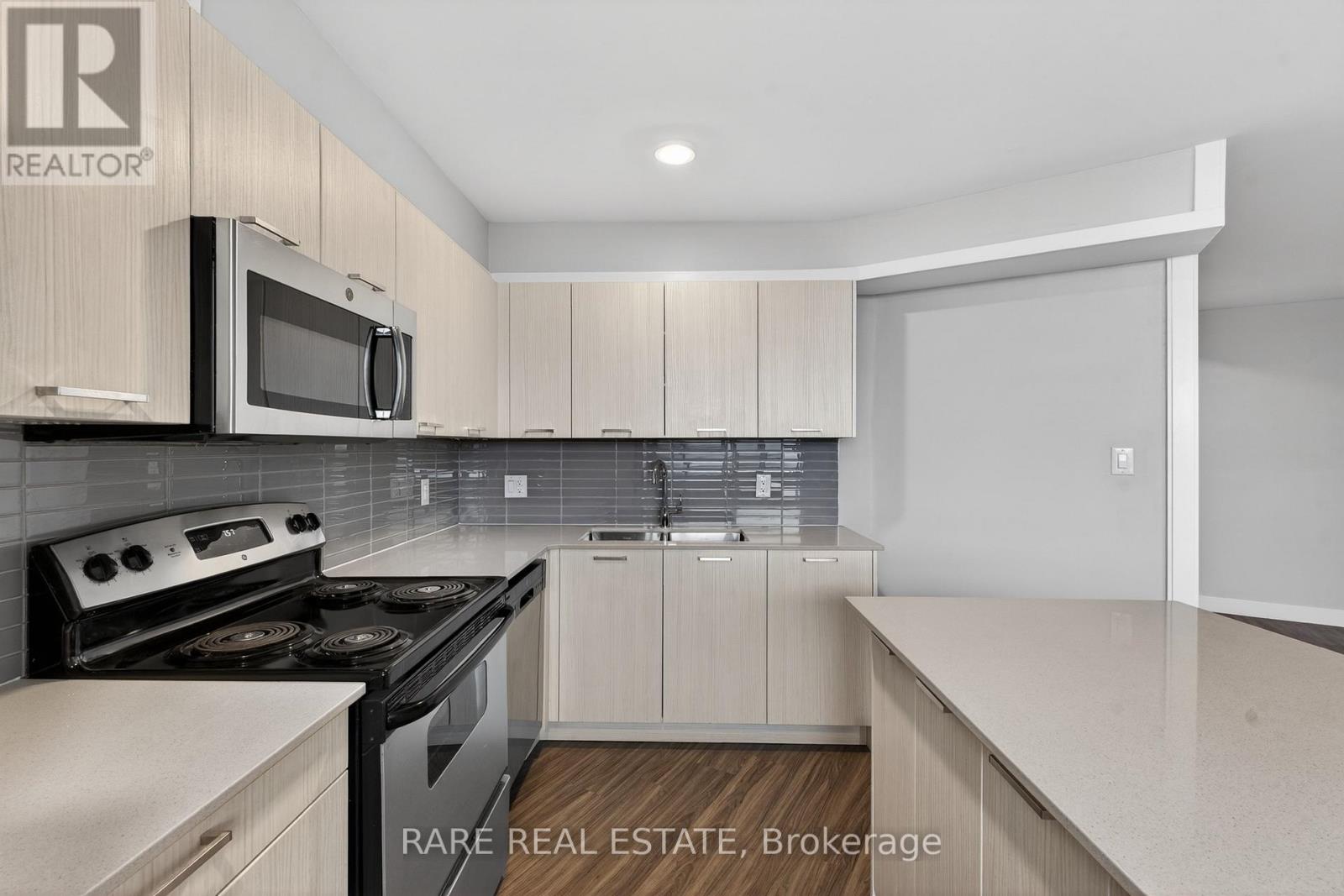 A kitchen with a stove top oven and microwave.
