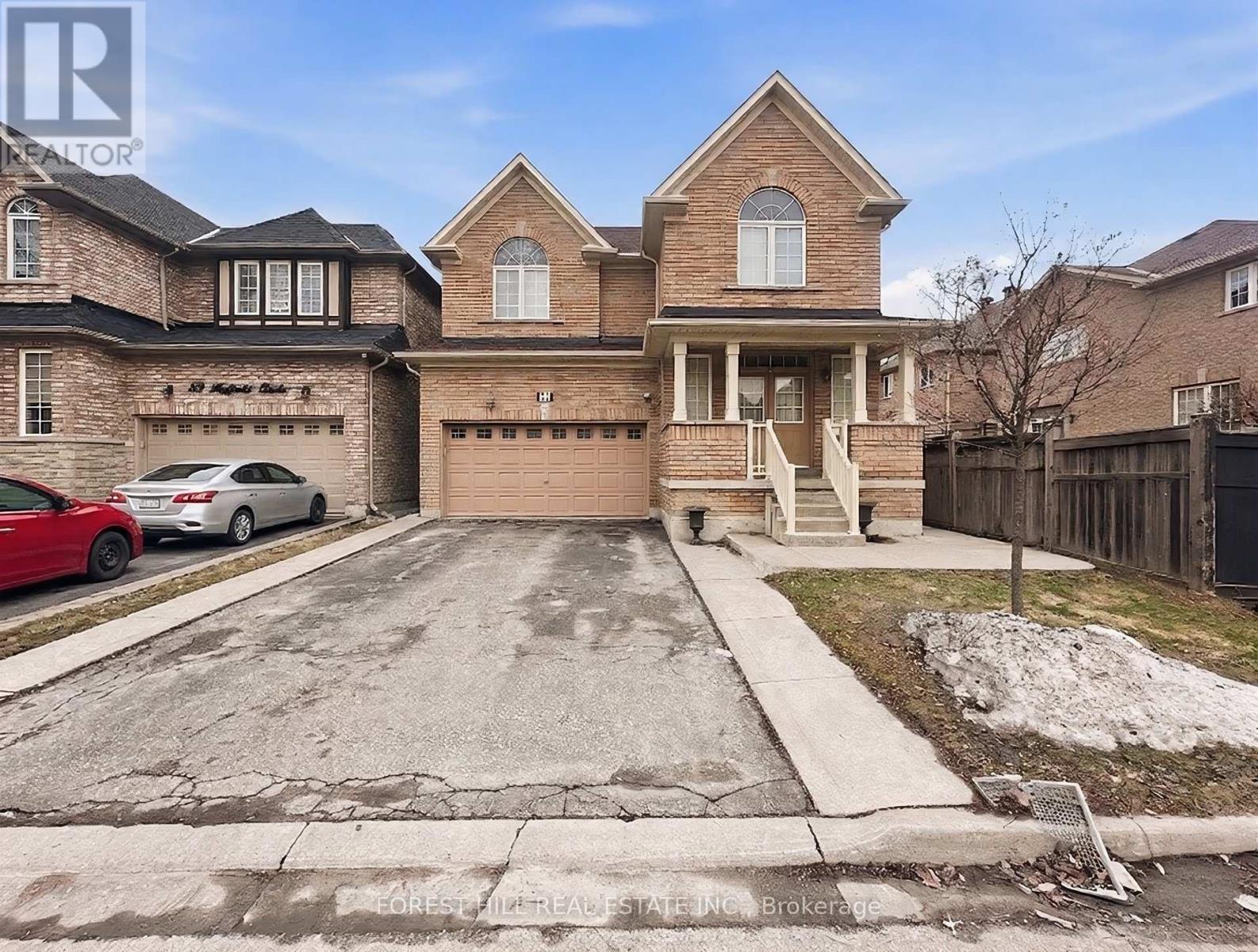 A large brick house with a car parked in front.
