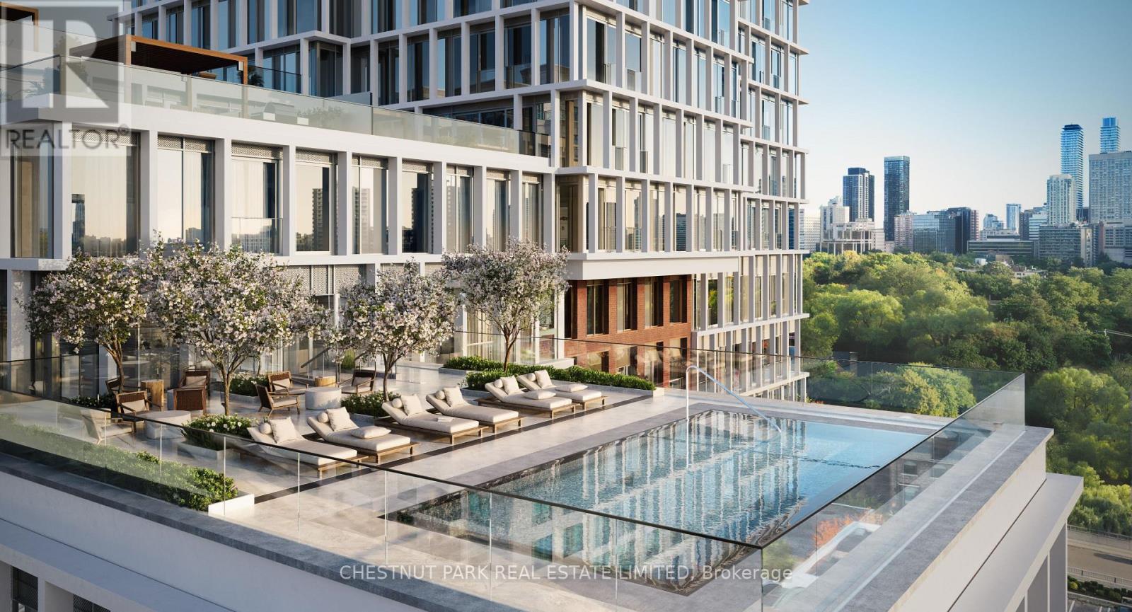 A modern building with a pool and lounge area in the foreground.
