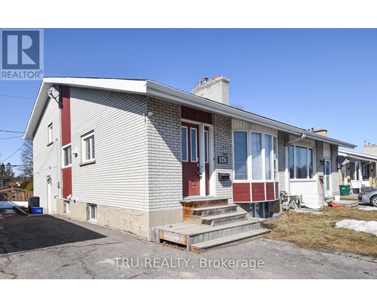A house with a red and white exterior is for sale through Tru Realty Brokerage.