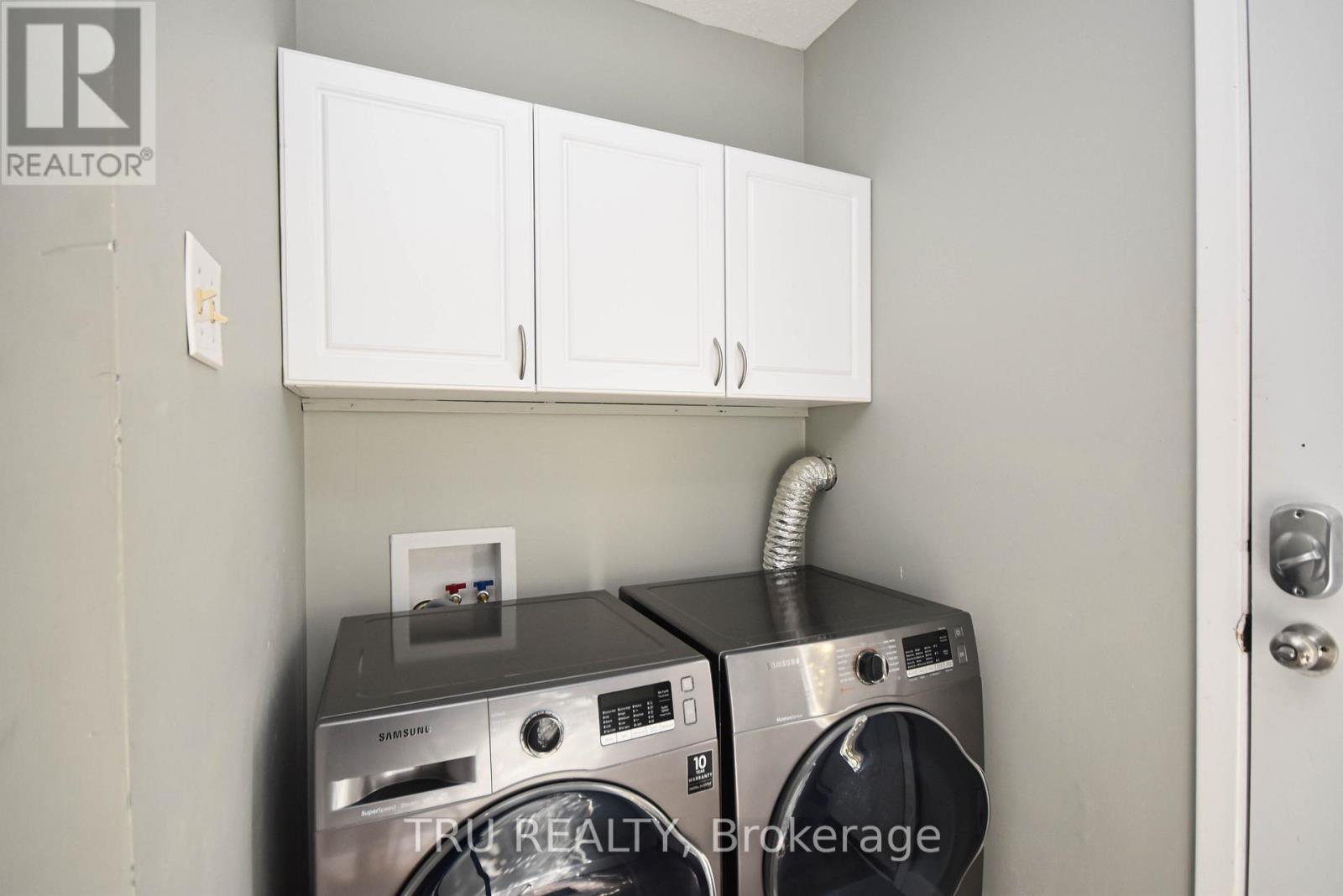 A washer and dryer are in a small laundry room.