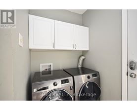 A washer and dryer are in a small laundry room.