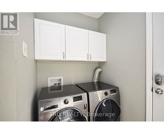 A washer and dryer are in a small laundry room.