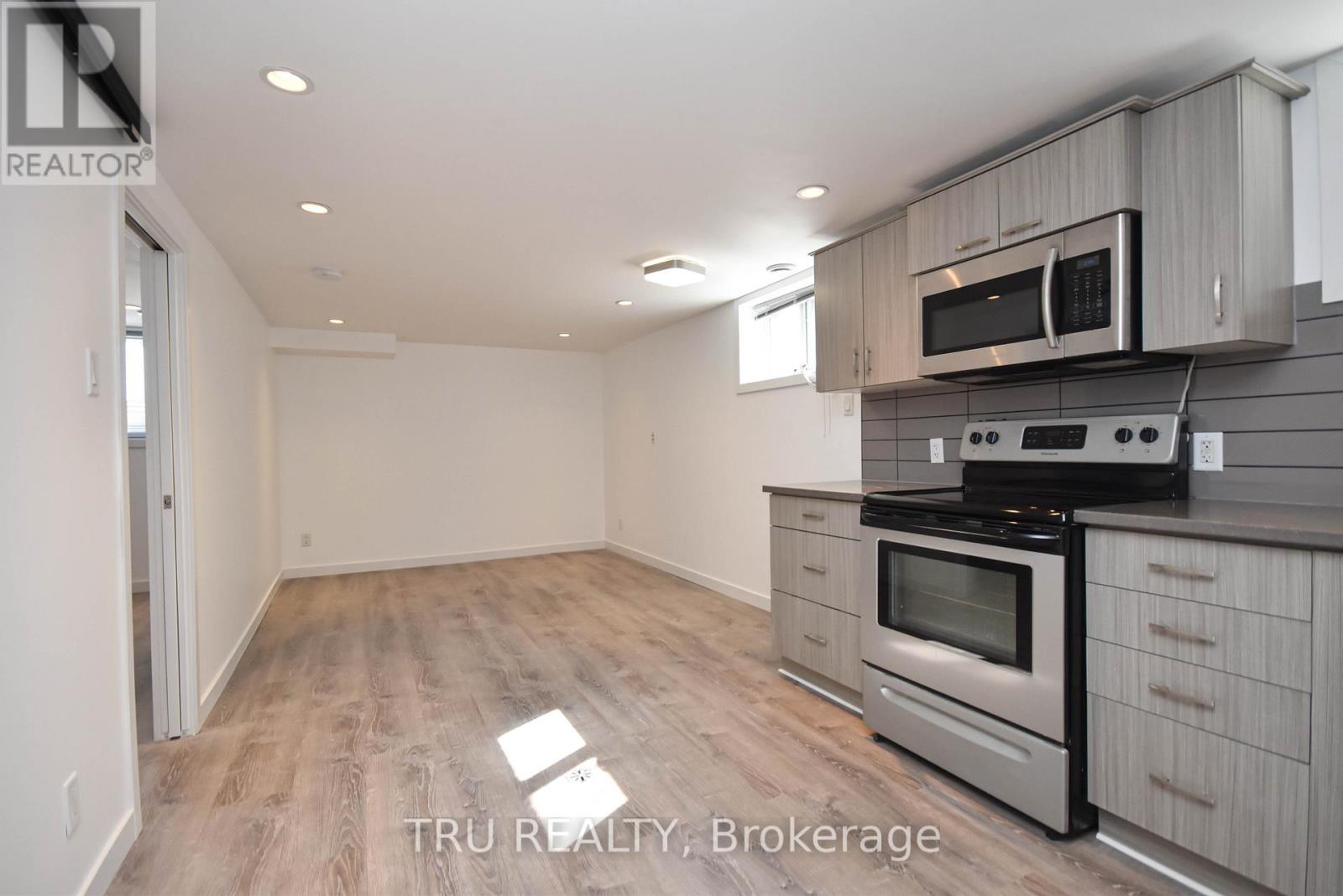 A kitchen with a stove top oven and microwave above it.