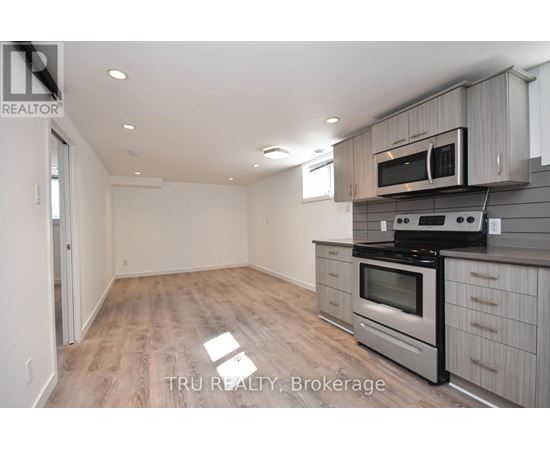A kitchen with a stove top oven and microwave above it.