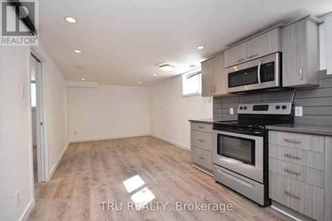 A kitchen with a stove top oven and microwave above it.