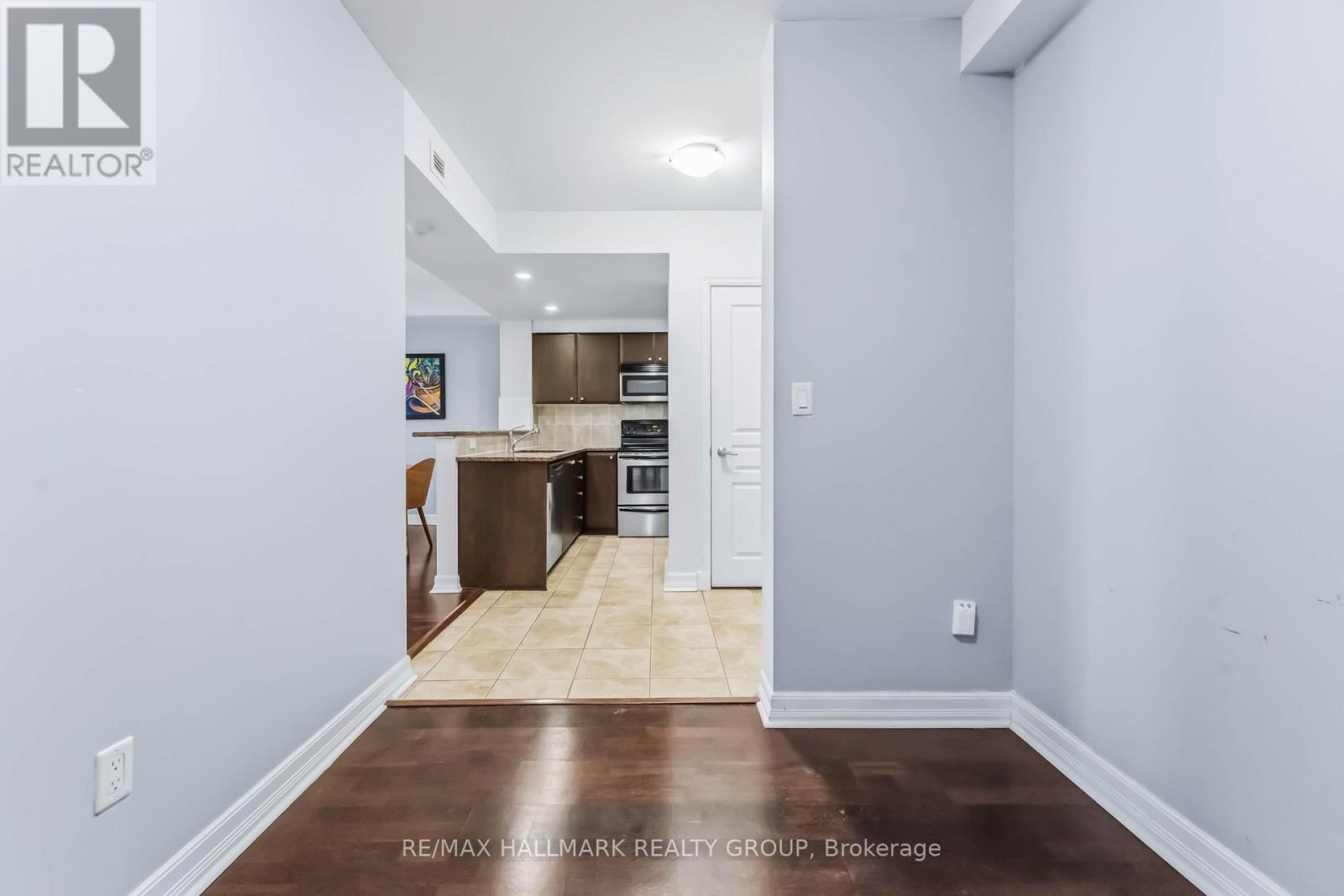A kitchen with a refrigerator, oven, and microwave.