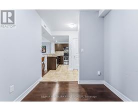 A kitchen with a refrigerator, oven, and microwave.