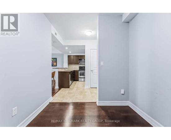 A kitchen with a refrigerator, oven, and microwave.