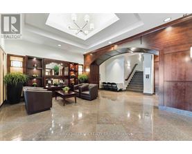 A spacious lobby with a staircase and a reception desk.
