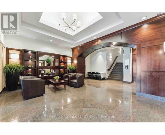 A spacious lobby with a staircase and a reception desk.