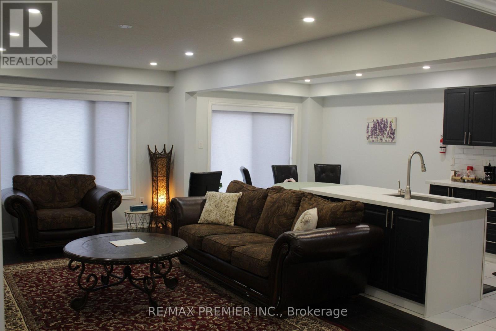A living room with a brown couch and a coffee table.