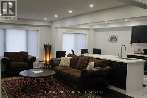 A living room with a brown couch and a coffee table.