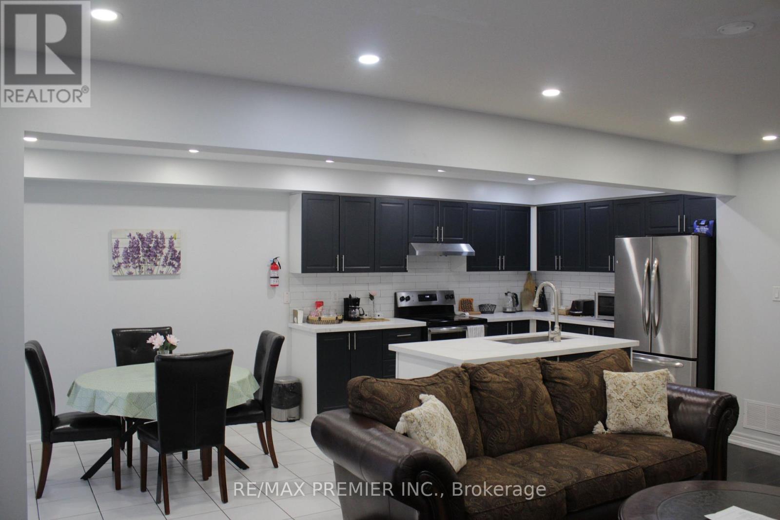A modern kitchen with a dining table and chairs.