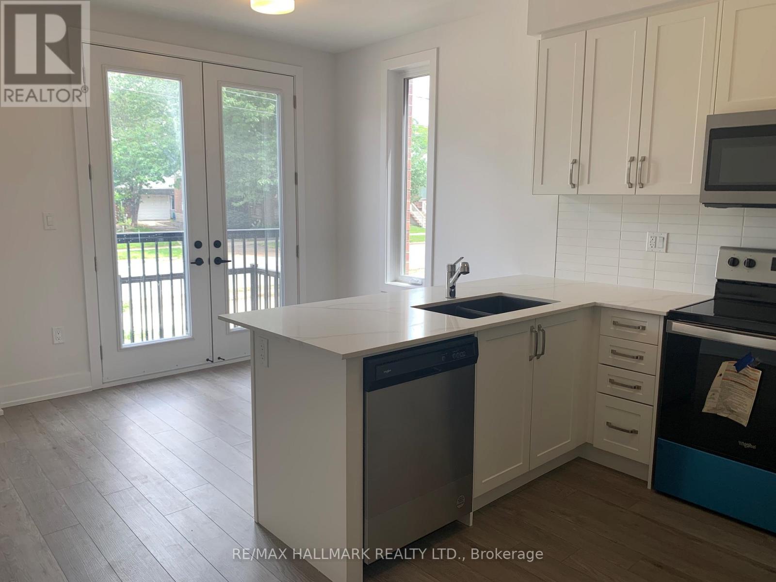 A kitchen with white cabinets and a blue dishwasher.