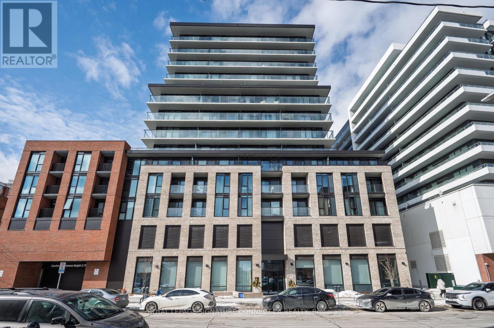 A modern building with a glass facade is the focal point of the image.