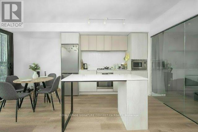 A modern kitchen with a dining table and chairs.