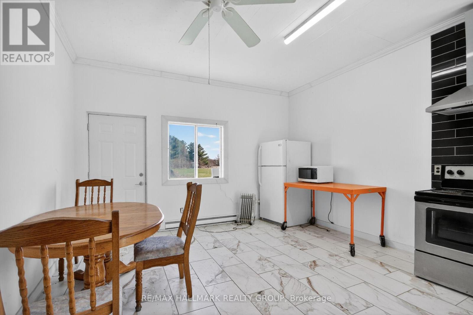 A dining room with a table and chairs.
