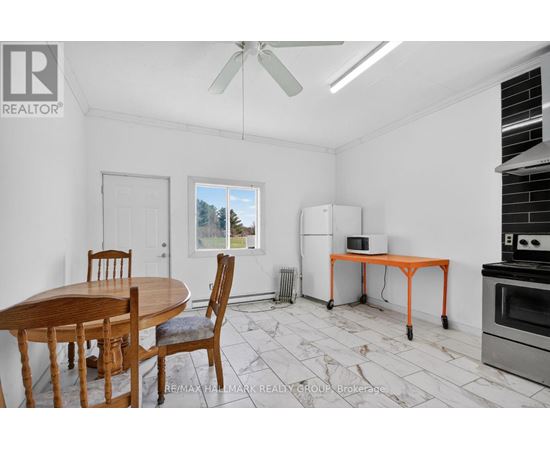 A dining room with a table and chairs.