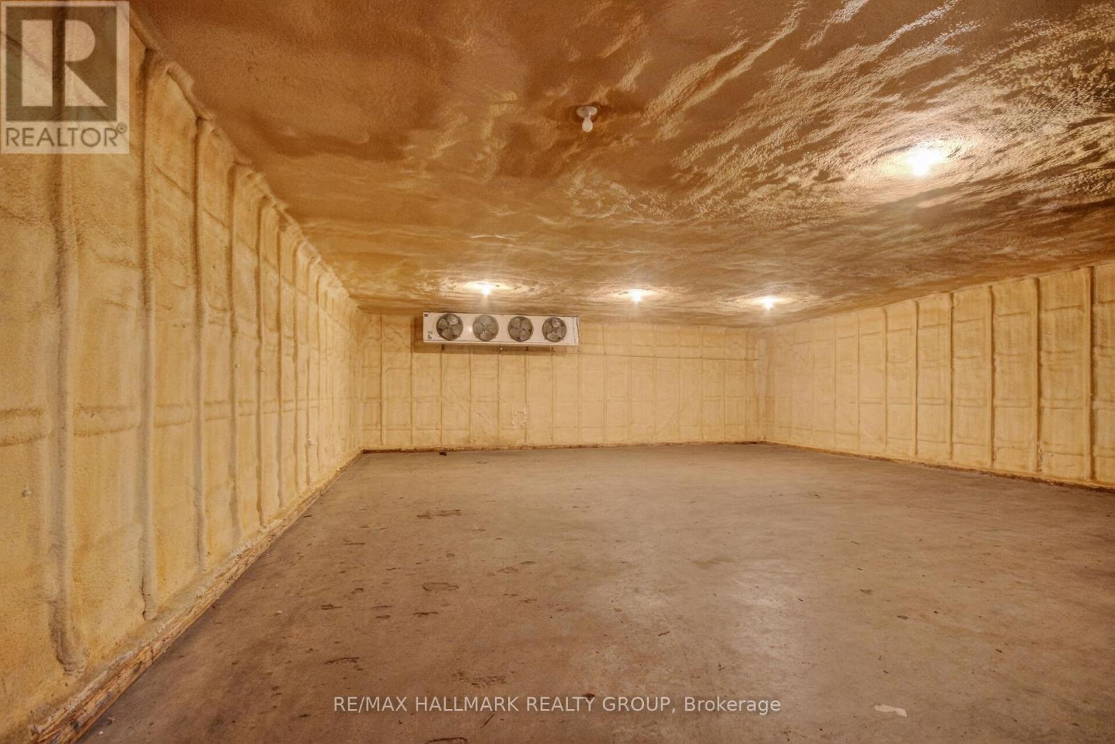 A spacious, unfinished room with wooden walls and ceiling.