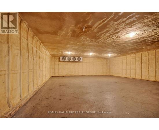 A spacious, unfinished room with wooden walls and ceiling.