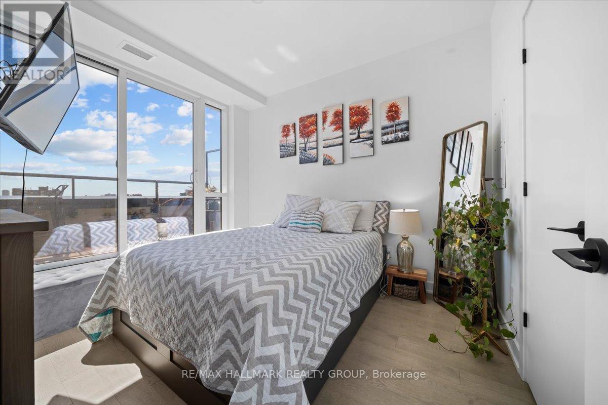 A bedroom with a large bed and a view of the outside.