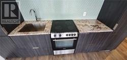 A kitchen with a sink, stove and oven.