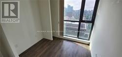 A room with a window overlooking a cityscape.